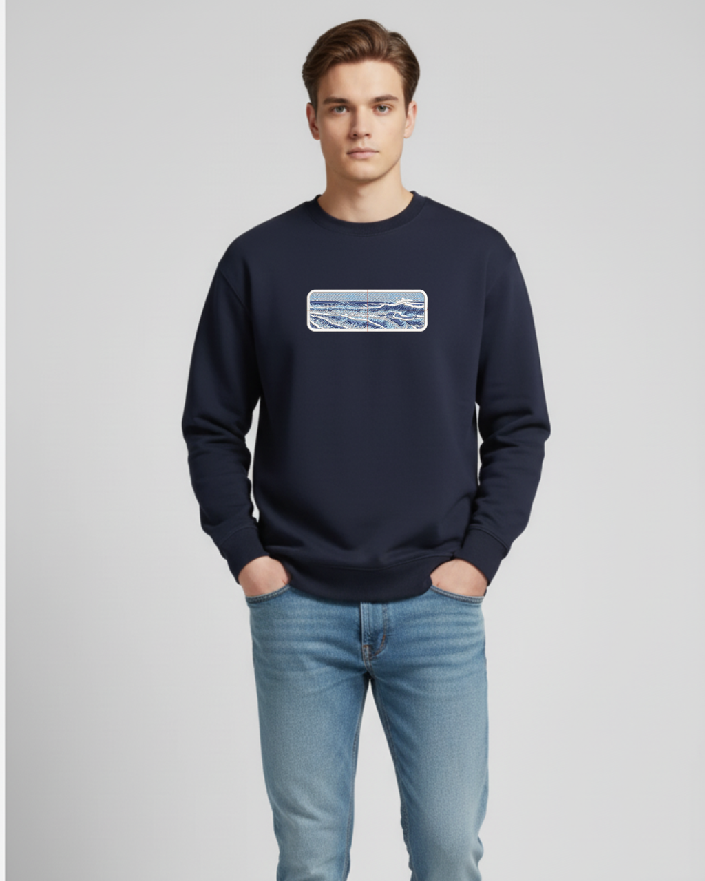 Man wearing a navy blue sweatshirt with a graphic design on a light gray background